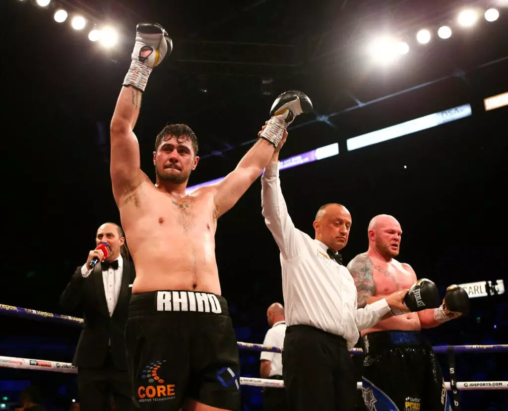 Dave Allen having his hand raised against Dorian Darch.