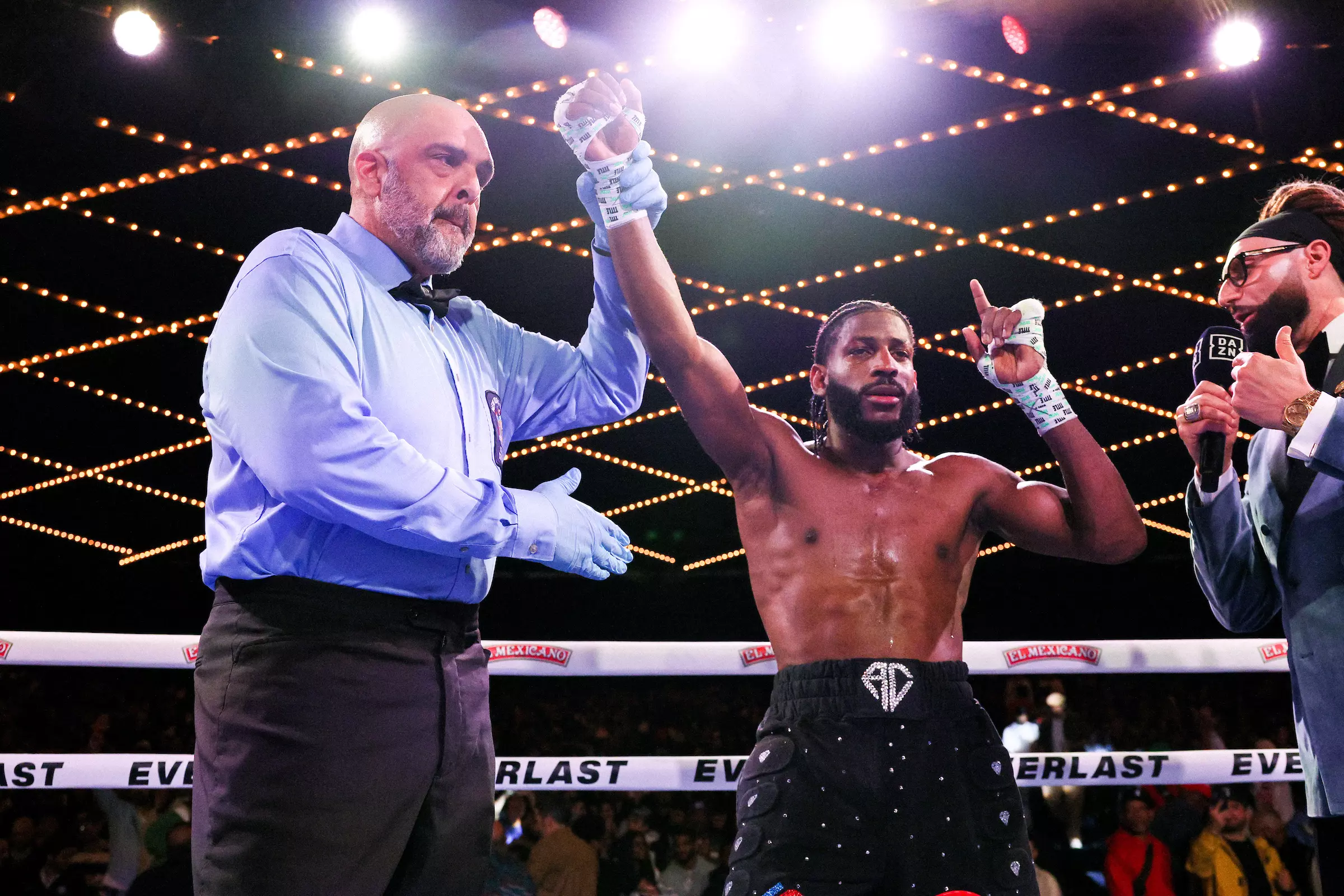 Andy Cruz with his hand raised by the referee