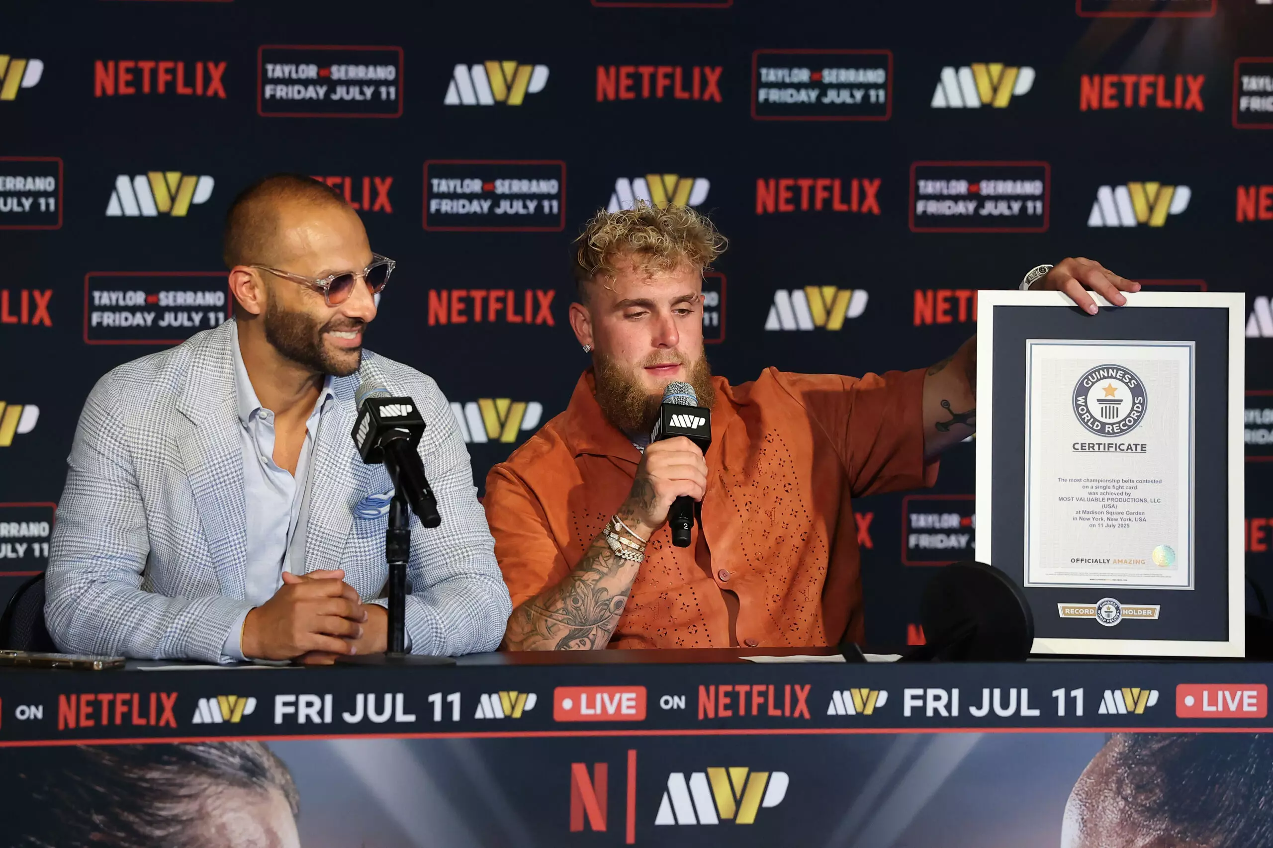 Nakisa Bidarian and Jake Paul are presented with a certificate from Guinness World Records after the event with the most world championship belts ever contested on a single fight card with Netflix's Katie Taylor vs Amanda Serrano 3 at Madison Square Garden on July 11, 2025 in New York City.