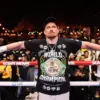 Oleksandr Usyk in the ring wearing a world champion t shirt