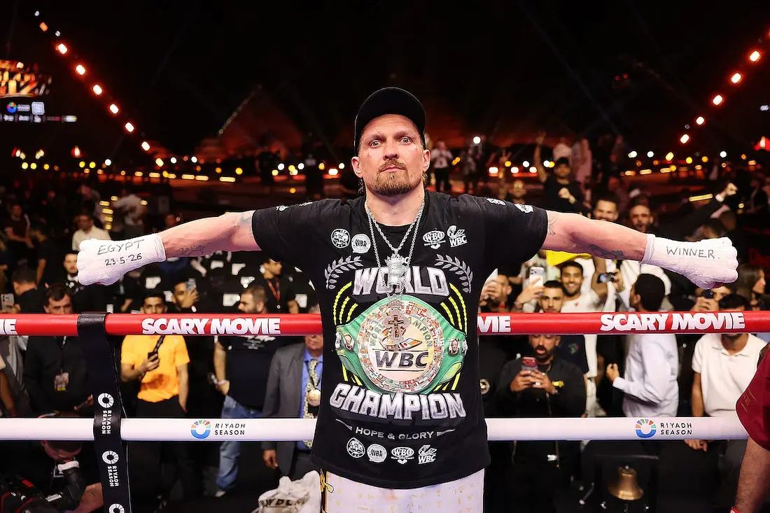 Oleksandr Usyk in the ring wearing a world champion t shirt