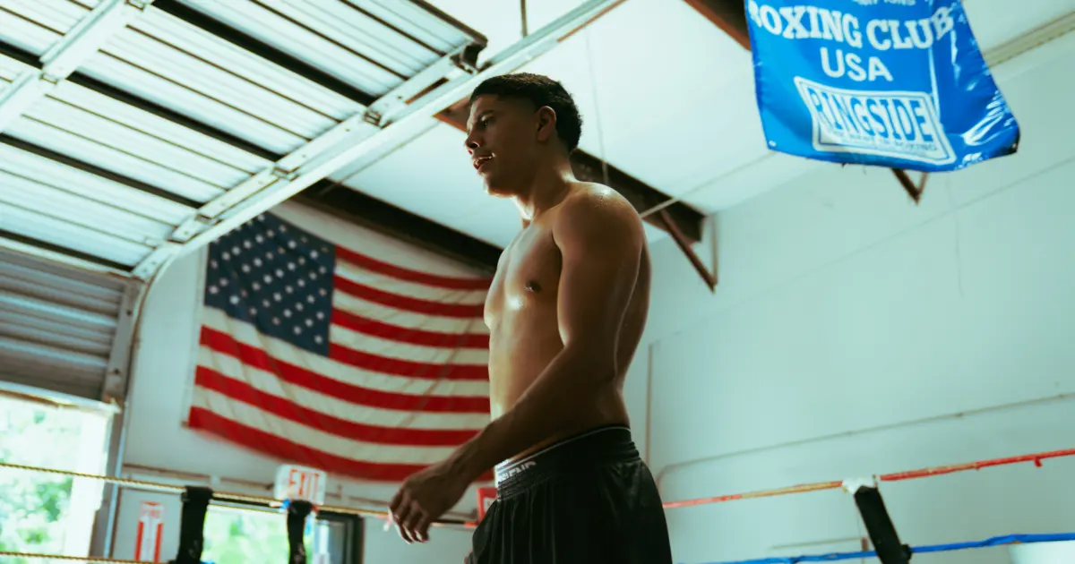 Antonio Vargas in training camp ahead of Bam Rodriguez fight with American flag above the ring.