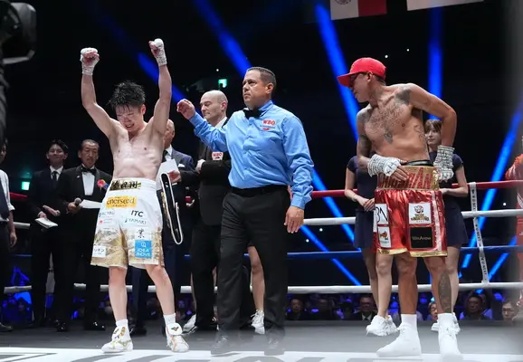 Kenshiro Teraji has his hand raised as the winner