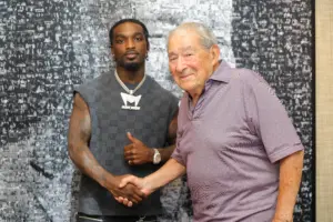 Frank Martin shaking hands with Bob Arum after signing with Top Rank