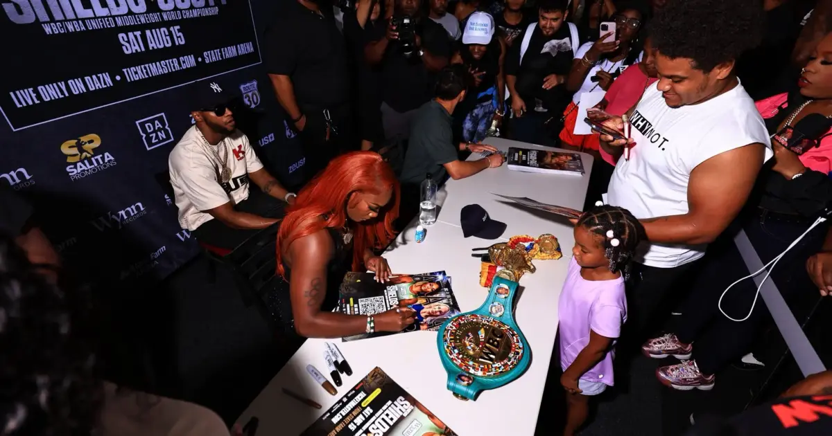 Kaye Scott vs Claressa Shields: Claressa Shields at fan signing with belts on display