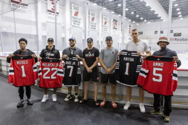 Andy Ruiz vs Damian Knyba: Andy Ruiz and Damian Knyba with main card fighters holding New Jersey Devils Jerseys